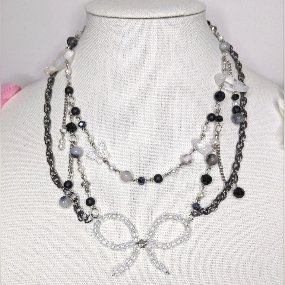 Necklaces with crystal and glass beads chain and a wired bow. Handmade by me.